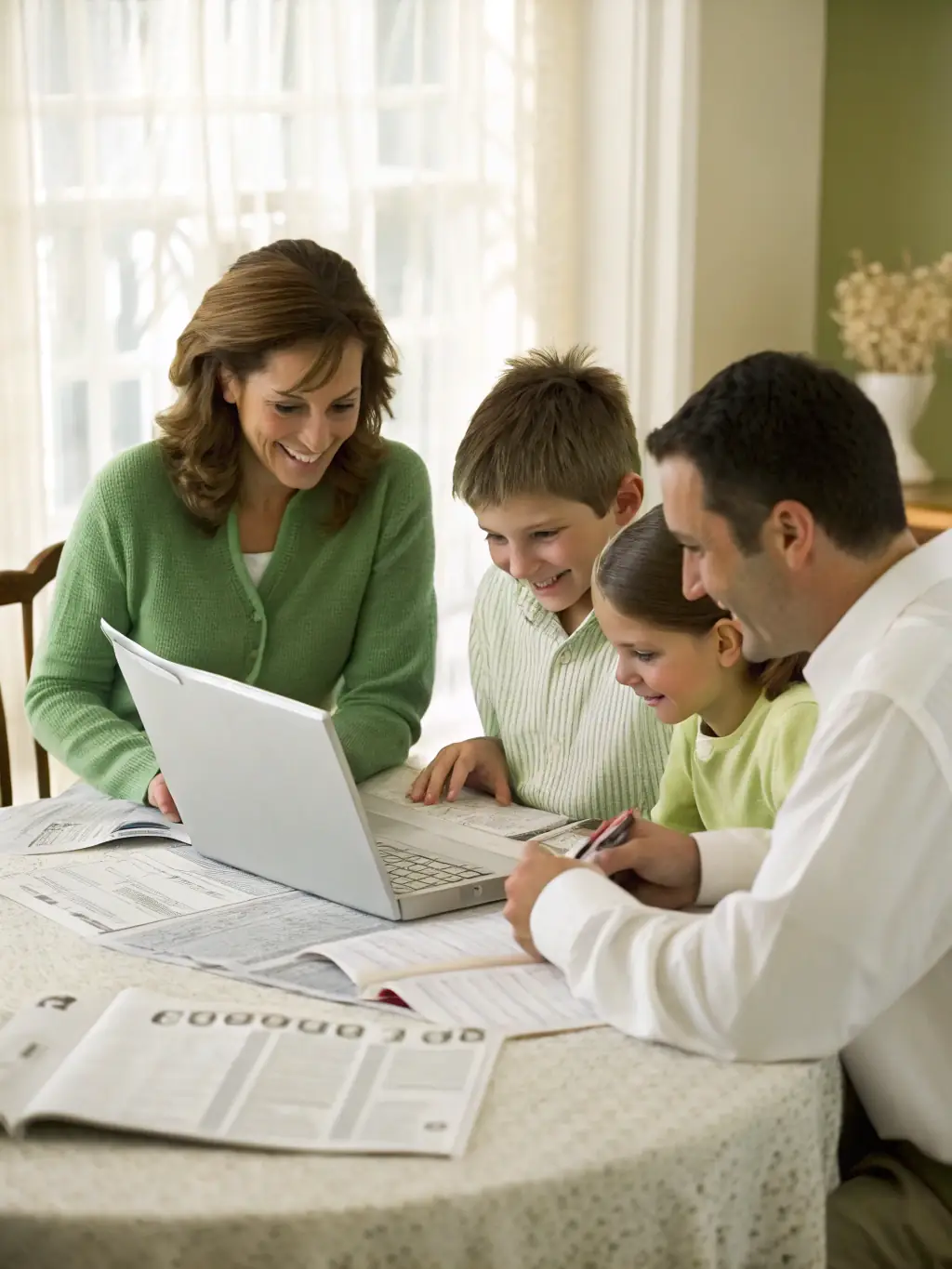A family looking stressed while reviewing bills and financial documents, symbolizing financial strain.